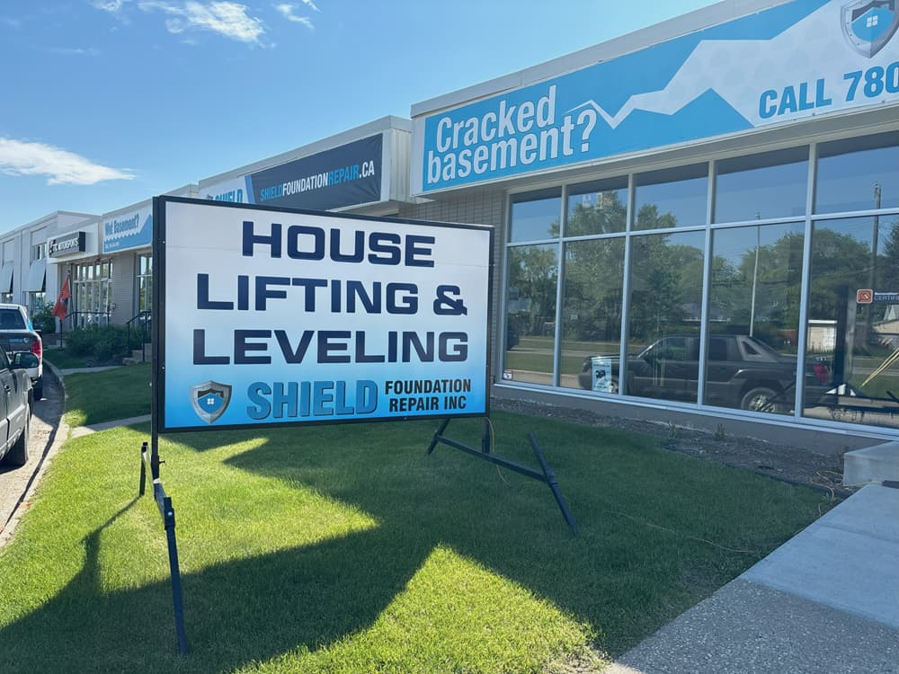 Image of Shield Foundation Repair office with "House Lifting" sign outside.